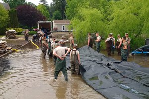 File - New York Army National Guardsmen deploy an AquaDam, a water-filled cofferdam, to control Lake Ontario’s high water levels at Sodus Point, N.Y., June 13, 2017.