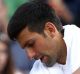 Novak Djokovic receives treatment on his injured elbow during his Wimbledon quarter-final.