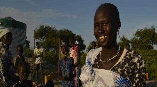 Nyawol Piu collects water from an Oxfam water tank in Jonglei state, South Sudan