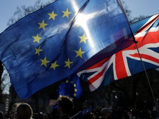 Demonstrators fly an EU and a Union flag during an anti-Brexit rally