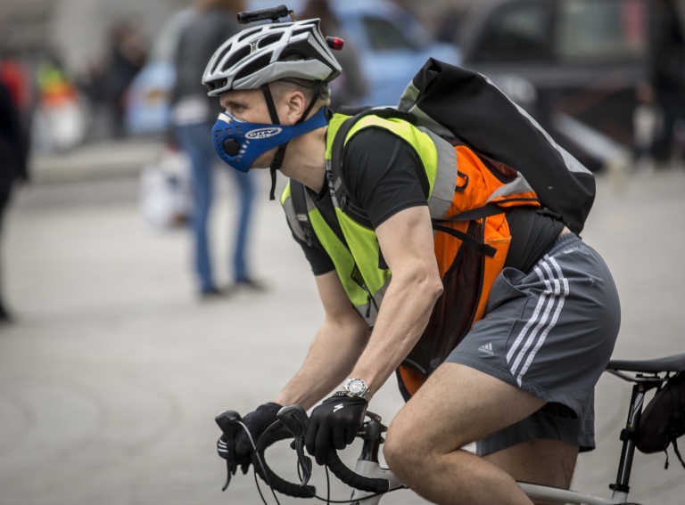 A cyclist wearing an anti-pollution mask  in London