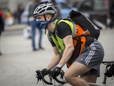 A cyclist wearing an anti-pollution mask  in London