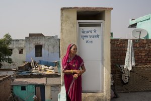 In this Tuesday, Oct. 6, 2015, Shakuntala Tanwar poses for a portrait next to a toilet in her house in the village of Hirmathla, in the state of Haryana, India.