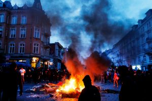 Protesters stay between fires on a street during a protest against the G-20 summit in Hamburg, northern Germany, Friday, ...
