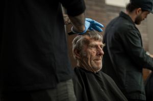 Nasir Sobhani (The Street Barber) cutting the hair of Max at the 'Christmas on the Streets' event for homeless held at ...
