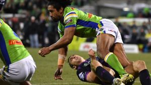 Billy Slater goes to ground after being collected high by Sia Soliola.