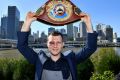 Bruised but not beaten: Jeff Horn proudly displays his WBO welterweight champion’s belt in Brisbane on Monday.