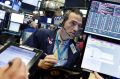 Trader Gregory Rowe works on the floor of the New York Stock Exchange, Wednesday, July 12, 2017. Stocks are opening ...