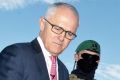 Prime Minister Malcolm Turnbull examines some military hardware during a media conference at Holsworthy Barracks on Monday.