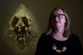 Anne Ryan, Curator of the Wynne Prize stands next to a sculpture by Juz Kitson.