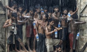 Migrants collect rainwater at a temporary refugee camp near Kanyin Chaung jetty, in Myanmar in June 2015. These Rohingya and Bangladeshis were rescued from a boat carrying 734 people off Myanmar's southern coast. They  had been at sea for more than two months - at the end with little food or water.  Photo: Reuters