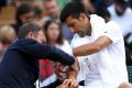 Novak Djokovic receives treatment on his injured elbow during his Wimbledon quarter-final.