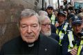 MELBOURNE, AUSTRALIA - JULY 26: Cardinal George Pell walks with a heavy Police guard from the Melbourne Magistrates' ...