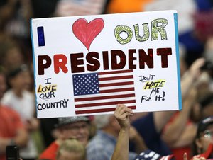 A supporter holds up a sign as President Donald Trump speaks at the Covelli Centre, Tuesday, July 25, 2017, in Youngstown, Ohio.