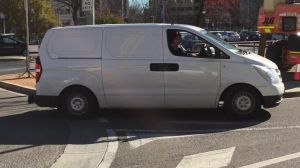 Taniela Manu Pikula, 29, being escorted by police in a van to court.