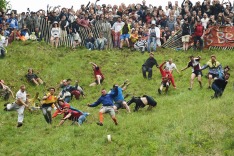 Competitors take part in the annual unofficial cheese rolling race at Cooper's Hill in Brockworth,  England  Monday May ...