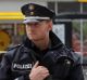 Police officers secure the area after the knife attack at a supermarket in Hamburg.