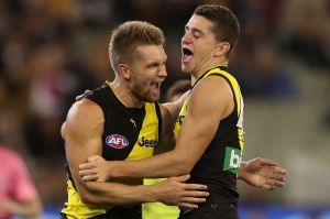 Tigers Dan Butler (left) and Jason Castagna celebrate after scoring a goal.