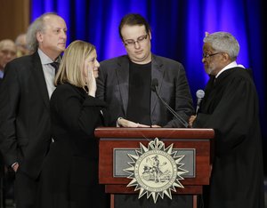 Nashville Mayor Megan Barry, second from left, is sworn into office by Judge Richard Dinkins, right, Friday, Sept. 25, 2015, in Nashville, Tenn.