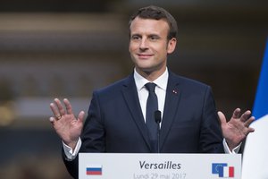 French President Emmanuel Macron gestures as he speaks at a joint news conference with Russian President Vladimir Putin at the Palace of Versailles as they meet for talks before the opening of an exhibition marking 300 years of diplomatic ties between the two countries, in Versailles, near Paris,