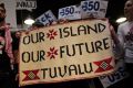 Activists supporting the tiny Pacific island of Tuvalu demand a better deal for island states at the UN climate summit ...