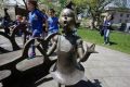 Children play near a bronze statue of a Dr Seuss character at the Dr Seuss National Memorial Sculpture Garden, in ...