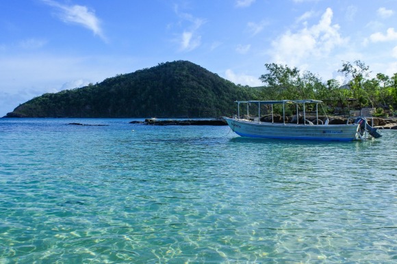 White sandy beach, blue water lagoon: Plantation Island Resort.