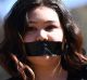 A student of the Australian National University participates in a protest after the release of the national student ...