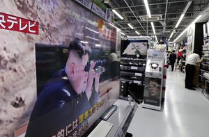 A TV news show an image of North Korean leader Kim Jong Un on a screen while reporting North Korea's missile test which landed in the waters of Japan's economic zone at a consumer-electronics retailer in Tokyo Tuesday, July 4, 2017.