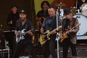 Tom Morello, Bruce Springsteen, and Nils Lofgren (L-R) of Bruce Springsteen and the E Street Band performs at the 2014 New Orleans Jazz & Heritage Festival at Fair Grounds Race Course on Saturday, May 3, 2014, in New Orleans.