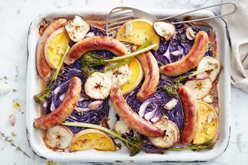 Easy pork and fennel sausage tray bake with apple cider and cabbage