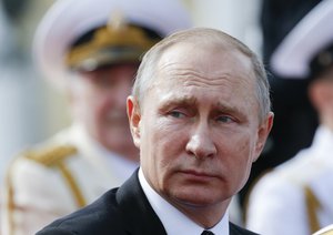 Russian President Vladimir Putin looks on attending the military parade during the Navy Day celebration in St.Petersburg, Russia, on Sunday, July 30, 2017.