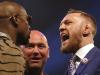 Boxers Connor McGregor, right and Floyd Mayweather left, are separated by UFC President Dana White, during a press conference to promote their upcoming fight, at the SSE Arena, in Wembley, London, Friday July 14, 2017. (Scott Heavey/PA via AP)