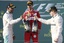 Ferrari driver Sebastian Vettel of Germany, center, Mercedes driver Lewis Hamilton of Britain, left, and Mercedes driver Valtteri Bottas of Finland toast each other following the Australian Formula One Grand Prix in Melbourne, Australia, Sunday, March 26, 2017. Vettel won ahead of Hamilton and Bottas was third.