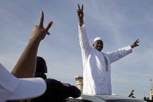 Gambian  President Adama Barrow  greets the crowds after arriving at Banjul airport in Gambia, Thursday Jan. 26, 2017, after flying in from Dakar, Senegal