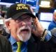 Trader Peter Tuchman, center, wears a "Dow 22,000" hat as he works on the floor of the New York Stock Exchange.