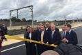 "It's my ribbon". 13 state and federal MP's get giddy about the opening of a road.