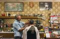 Barber Angelo Perri keeps busy at Paris Style Hairdresser, which looks like a perfectly preserved time capsule from the ...