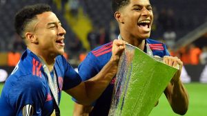 United's Jesse Lingard, left, and Marcus Rashford run with the trophy after winning the soccer Europa League final ...