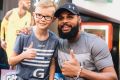 Patty Mills at Belconnen for a book signing for his new book <i>Game Day</i>. Mills congratulates Logan Harrison after ...