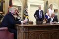 President Donald Trump speaks on the phone with Irish Prime Minister Leo Varadkar in the Oval Office of the White House.