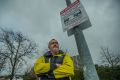 Wilson Parking enforcement officer Graham Bell and the signs installed to encourage people to pay for parking and ...