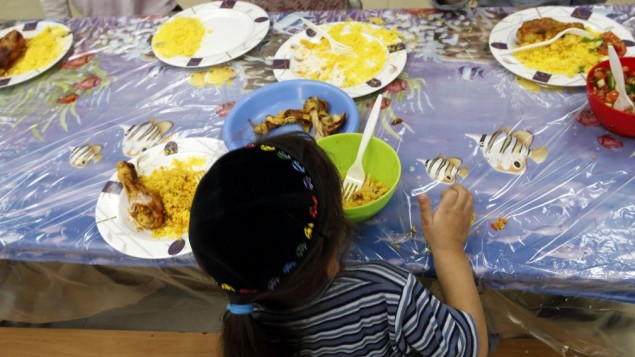 A young Jewish boy eats at the Yad Ezra V'Shulamit center in Jerusalem, which serves hot lunch every day to more than 1,200 children under the poverty line. September 27, 2011. (Uri Lenz/FLASH90)