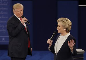 Republican presidential nominee Donald Trump and Democratic presidential nominee Hillary Clinton speak during the second presidential debate at Washington University in St. Louis, Sunday, Oct. 9, 2016.