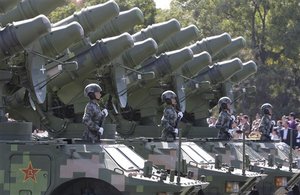 Chinese People's Liberation Army soldiers stand on military vehicles during a military parade marking China's 60th anniversary near the Tiananmen Square in Beijing, China, Thursday, Oct. 1, 2009.