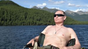 Russian President Vladimir Putin rests after fishing during a mini-break in the Siberian Tyva region.