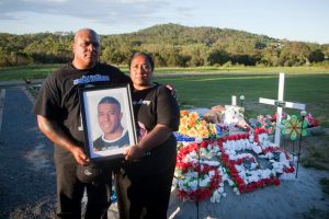 Too young: Peni and Lisa Fotuaika, parents of NRL player Mosese, pictured at the Brisbane cemetery where he was buried.