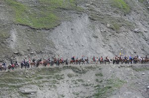 Indian Hindu pilgrims cross mountain trails during their religious journey to the Amarnath cave on the Baltal route, some 125 kilometers northeast of Srinagar, Jammu and Kashmir, India, 03 July 2016. Hindus believe the cave to be an abode of the god Shiva. The 59-day annual Amarnath yatra pilgrimage started 02 July 2015.