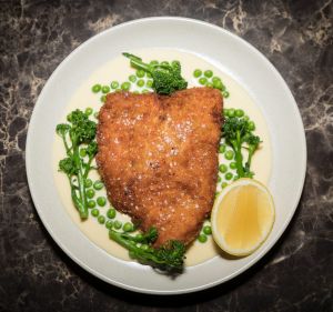 Chicken cotoletta, peas, broccolini and lemon parmesan cream.