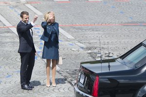 French First Lady Brigitte Macron and French President Emmanuel Macron wave bye to President Donald J. Trump, and First Lady Melania Trump as they depart the Bastille Day military parade in Paris, July 14, 2017.